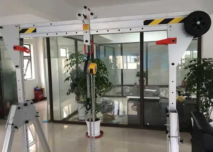 Foldable rolling gantry crane, undlfolded for material handling operation  Foldable rolling gantry crane, undlfolded for material handling operation