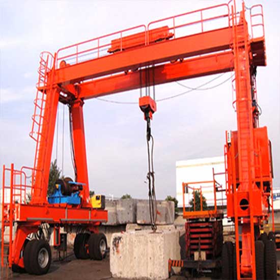 Rail mounted gantry crane with hook and container spreader