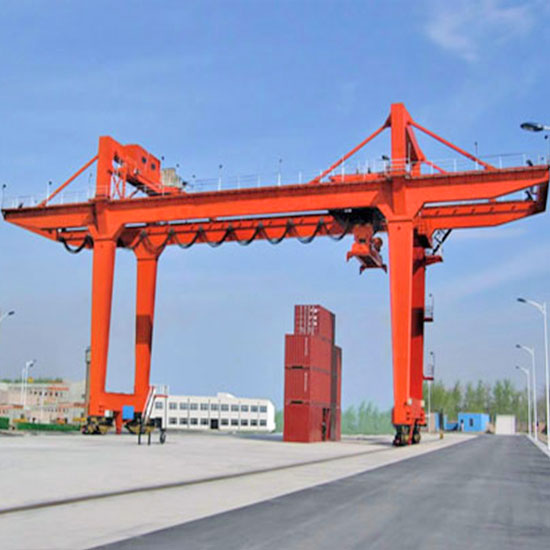 Rail mounted gantry crane with hook and container spreader