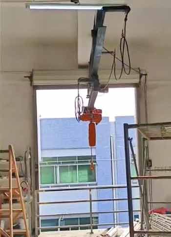 Ceiling mounted low headroom overhead bridge crane with telescoping cantilever crane design and electric chain hoist