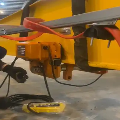 Powering and electric hoist trolley assembly 